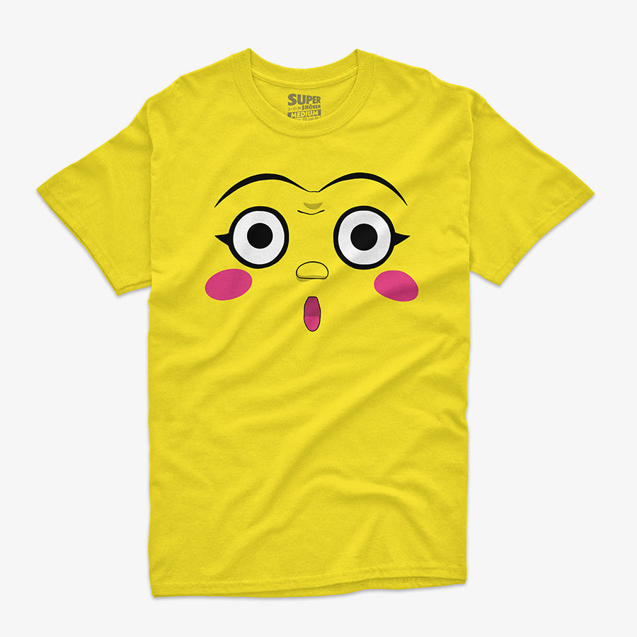 Polera amarilla de Dotto! Koni-chan. Diseno central de la cara de Koni-chan con grandes ojos blancos, rubor rosado en las mejillas y una boca pequena y abierta, con fondo amarillo