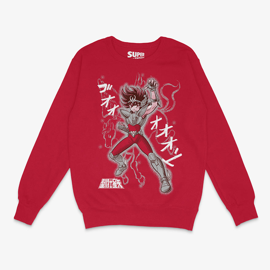 Polerón rojo de Saint Seiya. Diseño central de Seiya de Pegaso con su armadura, elevando el puño con el aura del cosmo alrededor, con onomatopeyas japonesas y la silueta del caballo Pegaso